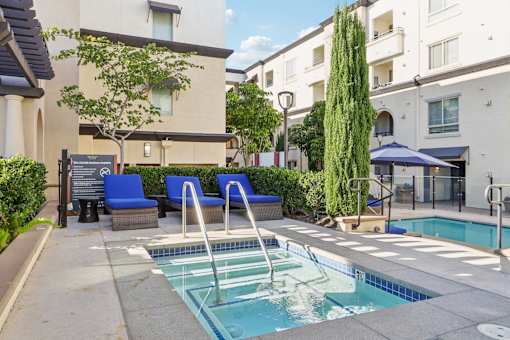 A small pool with a ladder in the middle of it.