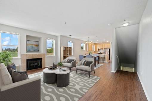 a living room with couches and chairs and a fireplace