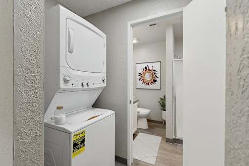 an empty laundry room with a washer and dryer in it