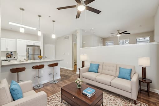 A living room with a white couch and a coffee table.