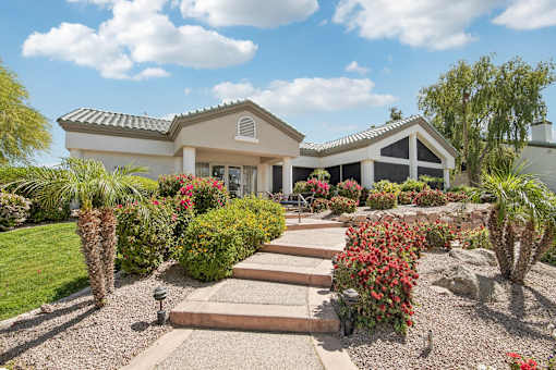 A house with a garden in front of it.