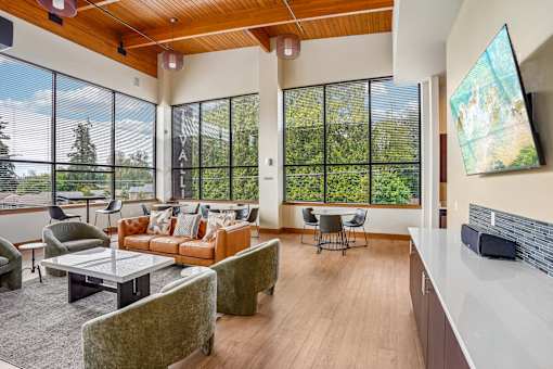 A living room with a couch, chairs, and a television.