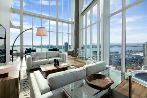 A modern living room with a view of the cityscape.