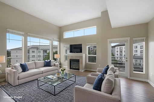 A living room with a couch, coffee table, and fireplace.