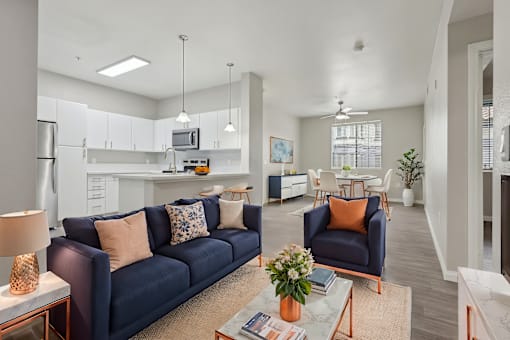 A living room with a blue couch and a coffee table.