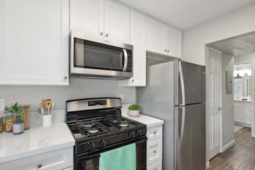 a kitchen with stainless steel appliances and white cabinets