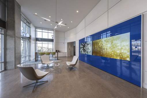 a room with a table and chairs and a large blue and yellow wall