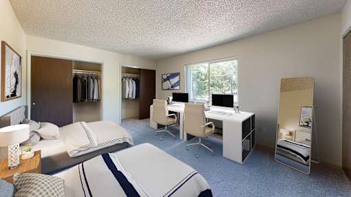 a bedroom with two beds and a desk with a computer