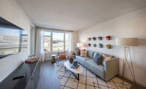 a living room with a couch and a table and a window