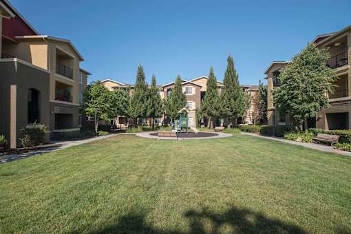 Tot Lot And Playing Field at Sterling Village Apartment Homes, California, 94590