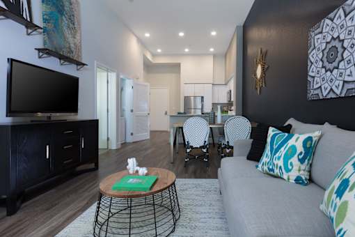 a living room with a couch and a table with chairs