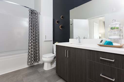 a bathroom with a toilet sink and bathtub in a 555 waverly unit