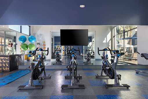 a spacious fitness center with treadmills and exercise bikes