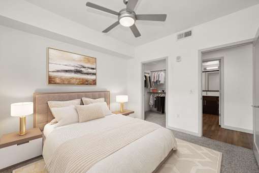 a bedroom with a large bed and a ceiling fan