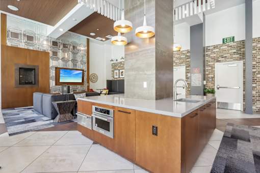 a kitchen with a large island and a living room with a fireplace
