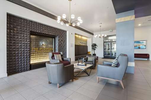 a lobby with couches and chairs and a fireplace