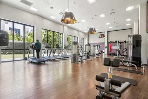 the gym at the district at highland village apartments