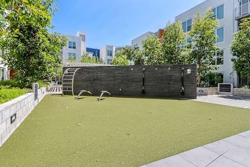 a backyard with a green lawn and a wooden fence