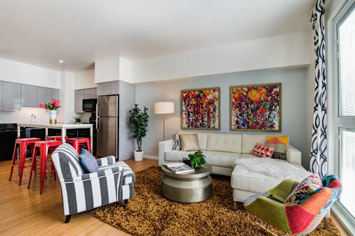 a living room filled with furniture and a large window