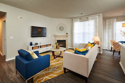 a living room with a couch and a chair and a television