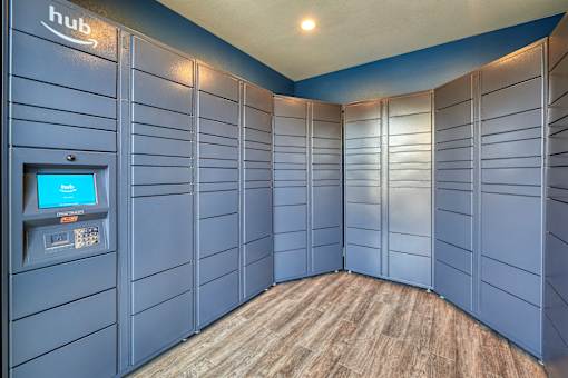 a bunch of blue lockers in a room with a coin machine