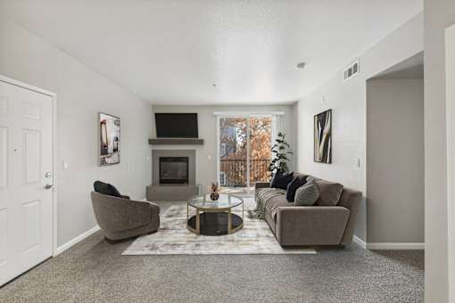 the living room of an apartment with couches and a table