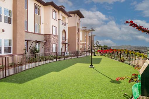 A building with a green lawn in front of it.