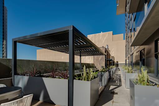 a pergola on a patio in front of a building