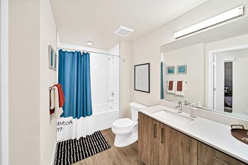 a bathroom with a large mirror and a toilet and a sink