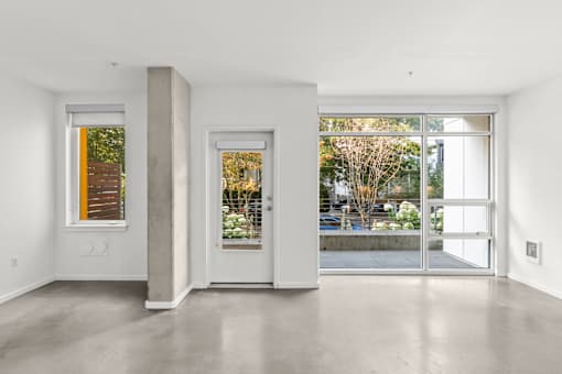 A white room with a door and a window.