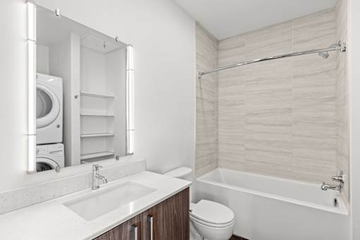 A white bathroom with a sink, toilet, and bathtub.