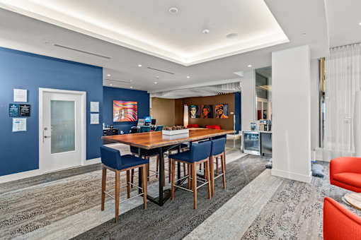 A dining area with a table surrounded by chairs.
