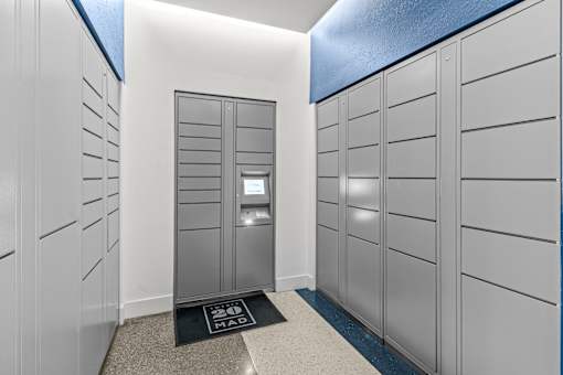 A hallway with a black mat on the floor that says "MAD".