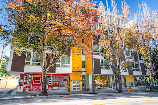 A building with a red fire hydrant in front of it.
