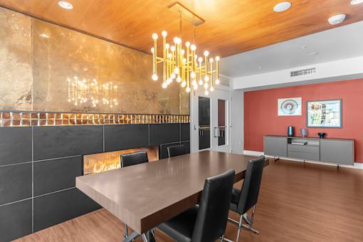 A modern dining room with a wooden table and chairs.