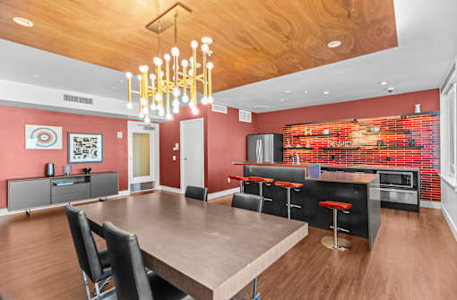 A modern dining room with a wooden table and chairs.