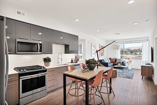 an open kitchen and living room with a table and chairs