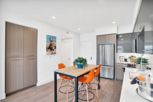 a kitchen and dining room with a table and chairs