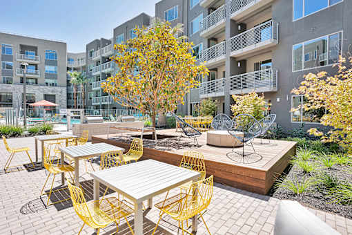 an outdoor patio with tables and chairs