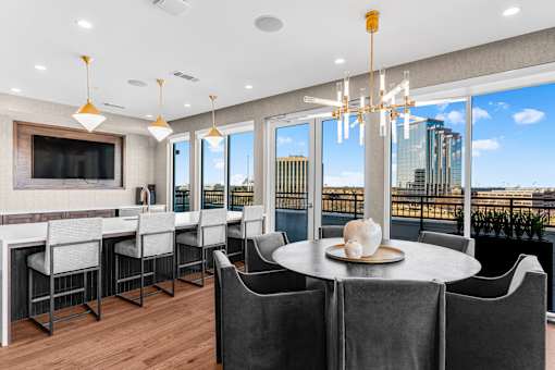 A modern dining room with a view of the city.