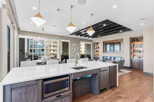 A modern kitchen with a white countertop and dark wood cabinets.