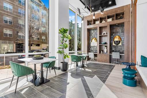 A modern living room with a dining table and chairs.
