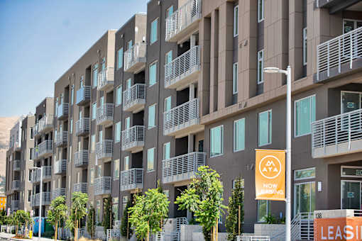 a building with balconies and trees in front of it
