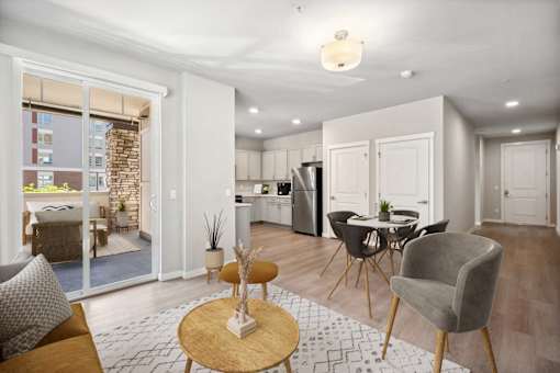 a living room with a table and chairs and a kitchen