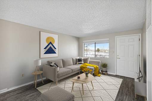 a living room with a couch and a door to a balcony