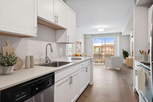 an open kitchen and living room with a view of a balcony