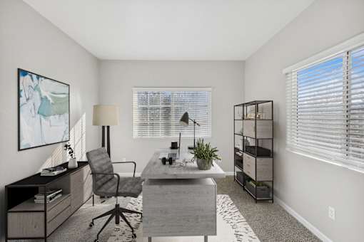 an office with a desk and a chair and a window