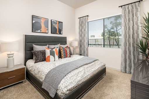 our apartments offer a bedroom with a bed and a large window