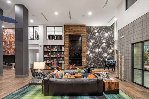 a living room with a large leather couch and a fireplace