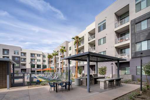 our apartments have a large patio with tables and chairs and a pool